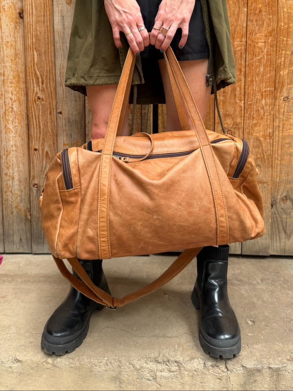 Luke Bag – Lifestyle Photo – Lady Carrying Toffee Leather Duffel Bag