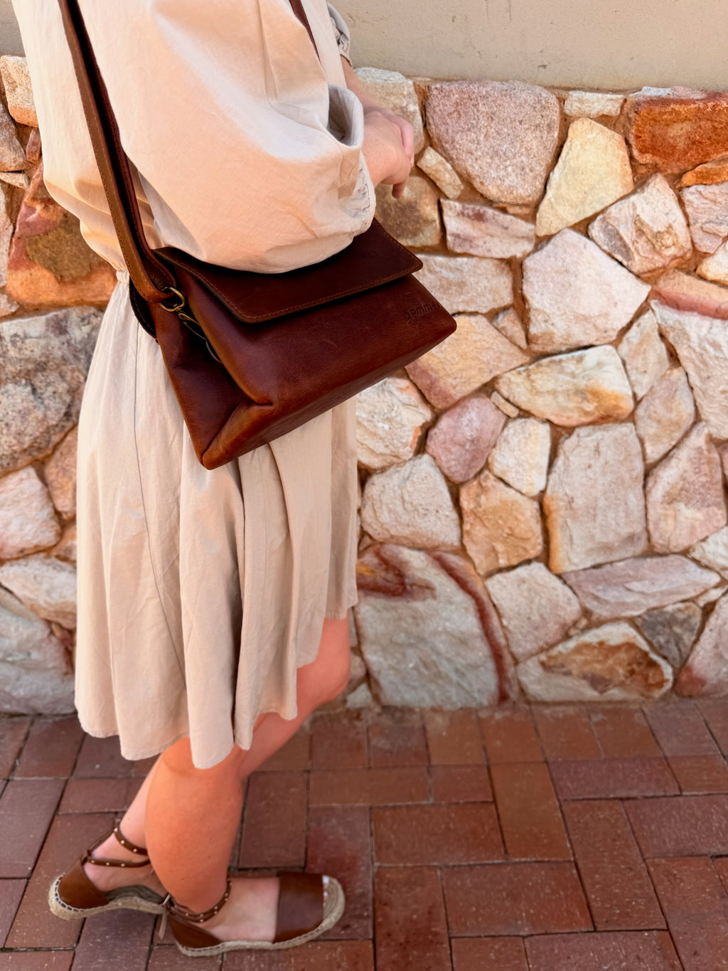 TRVL Sling Bag – Lifestyle Photo – Lady Carrying Tobacco Leather Bag