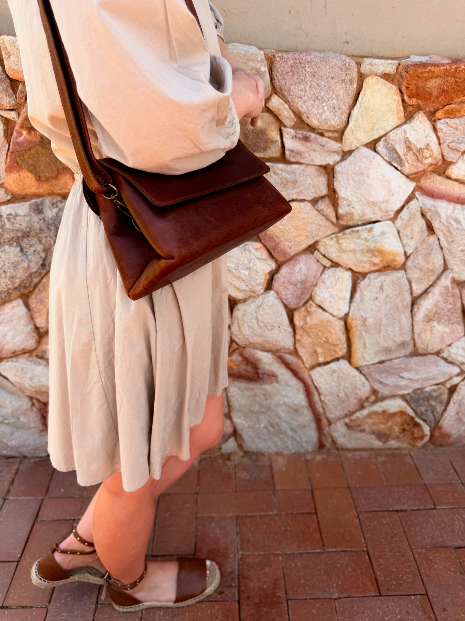 TRVL Sling Bag – Lifestyle Photo – Lady Carrying Tobacco Leather Bag